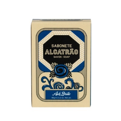 Caixa de sabonete beige com detalhes azuis e pretos e texto impresso