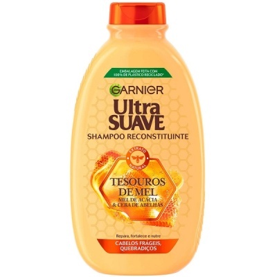 Frasco amarelo de shampoo Garnier Ultra Suave Tesouros de Mel com tampa laranja