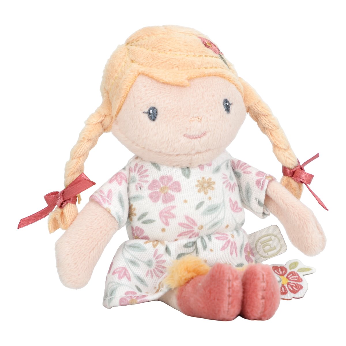 Boneca de pelúcia com vestido floral e cabelo loiro em tranças.