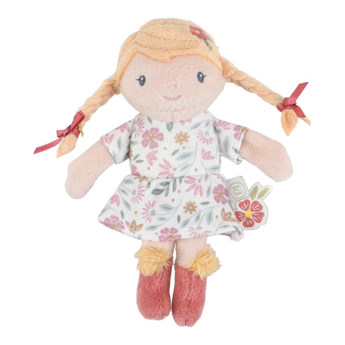 Boneca de pano com vestido floral e cabelo em tranças com fitas cor-de-rosa