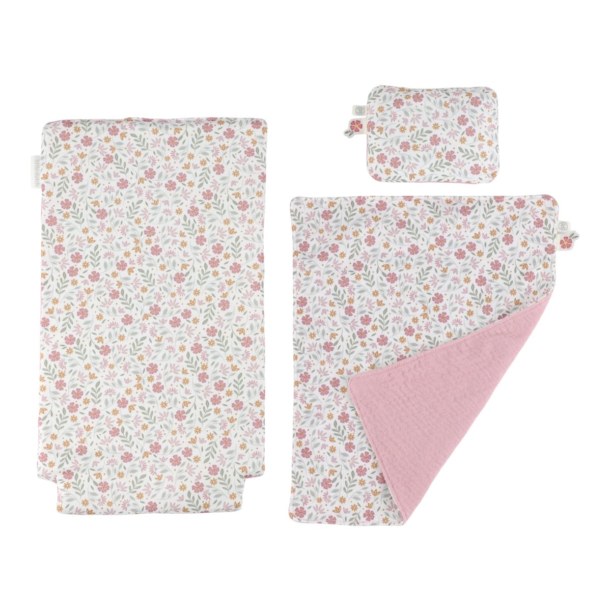 Conjunto de têxteis florais cor-de-rosa, laranja e verdes sobre fundo branco, um reversível cor-de-rosa