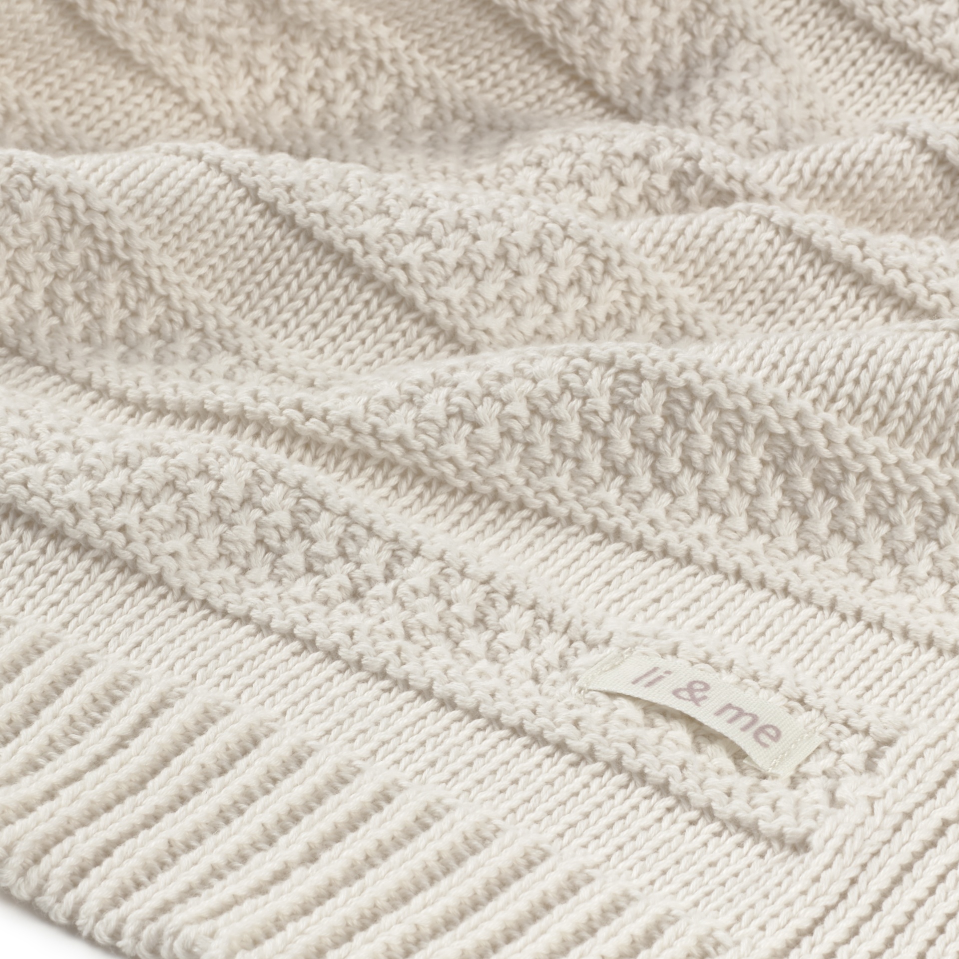 Textura de manta de malha clara com etiqueta li & me