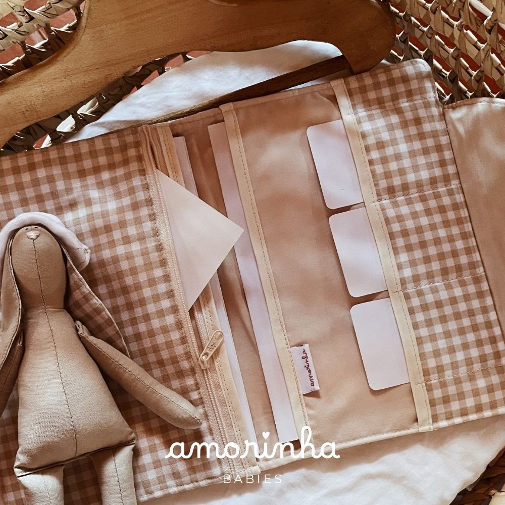 Carteira organizadora bege com padrão xadrez e boneco de pano ao lado