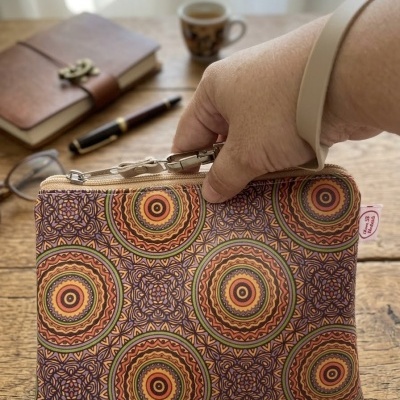 Bolsa pequena retangular com padrão circular colorido em tecido