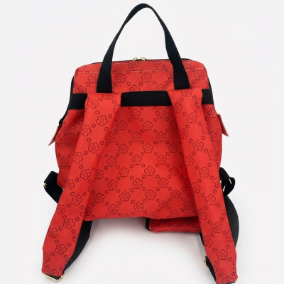 Mochila vermelha com padrão floral preto e alças pretas