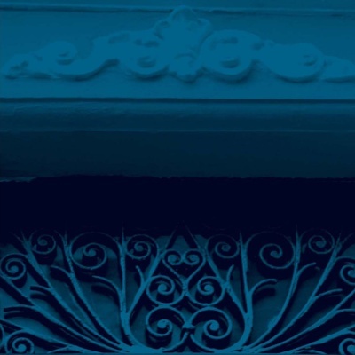 Grade decorativa em ferro forjado azul com padrão de espirais e folhas