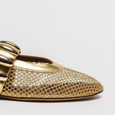 Sapatilha dourada com malha e detalhe metálico em fundo branco