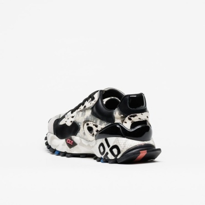 ténis desportivo branco e preto com padrão de pele de vaca