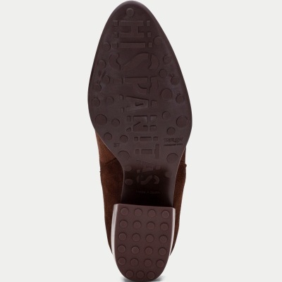 Sola de sapato castanho com padrão de círculos e texto em relevo