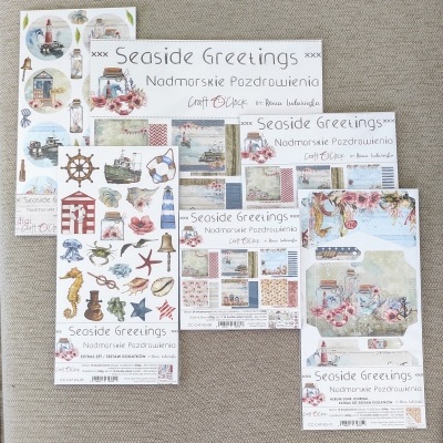 Papelaria temática marítima com desenhos náuticos e texto 'Seaside Greetings'.