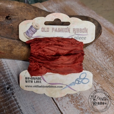 Fita vermelha enrugada em cartão com texto OLD FASHION RIBBON