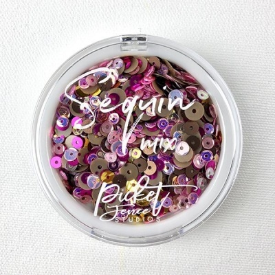 Pote de plástico com lantejoulas coloridas e texto na tampa