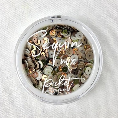 Recipiente redondo com lantejoulas variadas e texto na tampa.