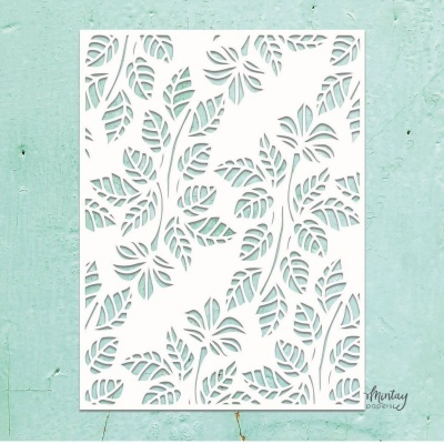 Stencil de papel branco com padrão de folhas tropicais recortadas num fundo azul claro