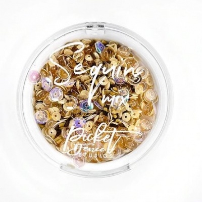 Pote redondo transparente com lantejoulas douradas e texto branco na tampa