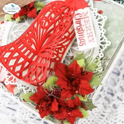 Caixa vermelha recortada com flores vermelhas e etiqueta 'MERRY Christmas'