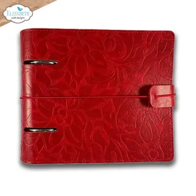Caderno vermelho com padrão floral em relevo, fecho de botão com tira elástica e argolas metálicas prateadas