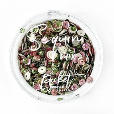 Caixa redonda com lantejoulas coloridas e texto na tampa