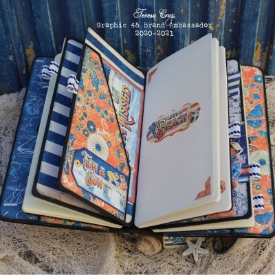 Álbum artesanal tropical aberto com decoração náutica e textos temáticos