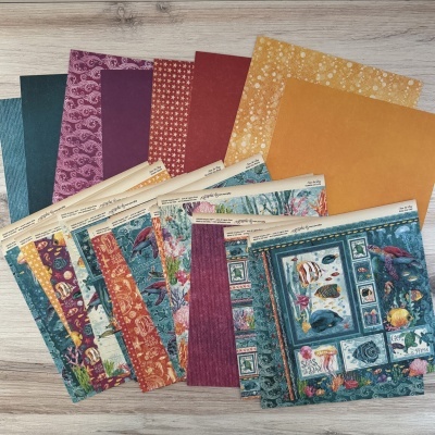 Conjunto de papéis decorativos com tema marinho em várias cores e padrões