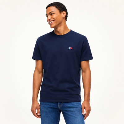 Camiseta azul marinho Tommy Jeans usada por modelo com calças de ganga