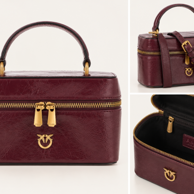 Burgundy leather handbag with gold zipper and emblem, handle and strap, with interior label PINKO.