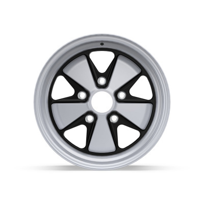 Silver and black car wheel rim with triangular spokes