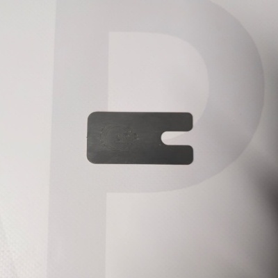 Black rectangular clip with U-shaped cutout and embossed text 'CAP' on white background with large faint letter P