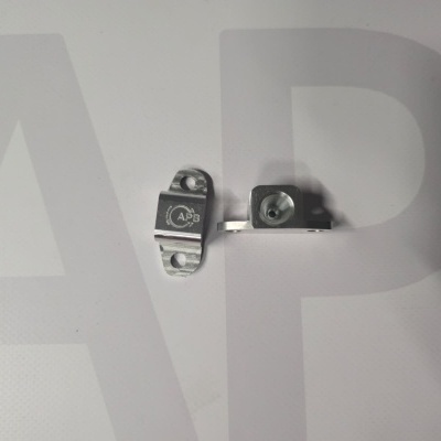 Two small silver metal brackets with APB engraving on a white background