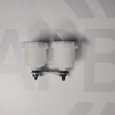 Two white plastic fluid reservoirs with black caps on white surface