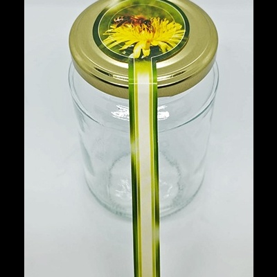 Frasco de vidro com tampa metálica e etiqueta com imagem de abelha