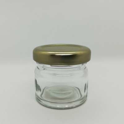 Frasco pequeno de vidro com tampa metálica dourada