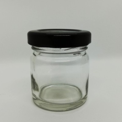 Frasco pequeno de vidro transparente com tampa preta