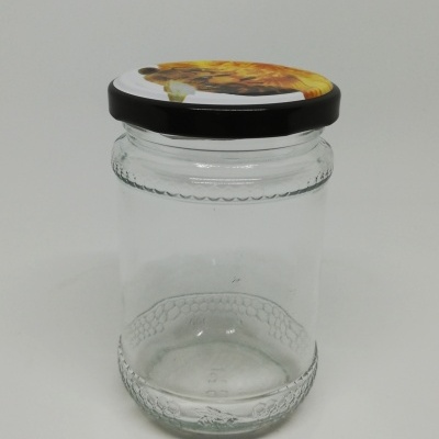Frasco de vidro com tampa preta e imagem de girassol