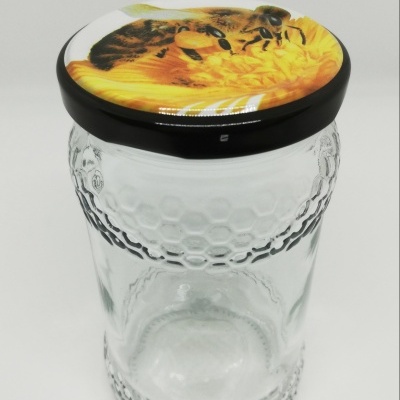 Frasco de vidro com tampa decorada com imagem de abelha