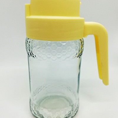 Frasco de vidro com tampa e pega amarelas