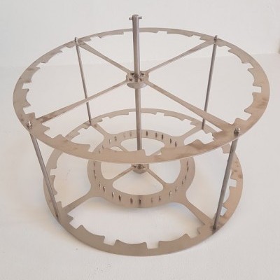 Estrutura metálica redonda com rodas dentadas prateadas e hastes verticais em fundo branco