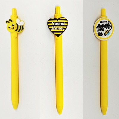 Conjunto de esferográficas amarelas decoradas com temas de abelhas e mel
