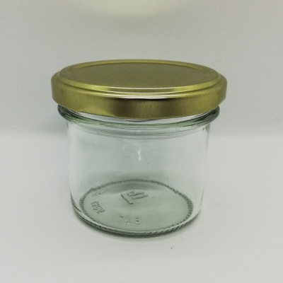 Frasco de vidro transparente com tampa metálica dourada