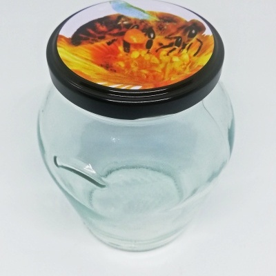 Frasco de vidro com tampa preta decorada com imagem de abelha e flores