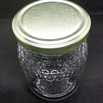 Frasco de vidro transparente com tampa metálica prateada