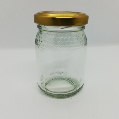 Frasco de vidro transparente com tampa dourada