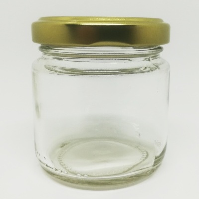 Frasco de vidro transparente com tampa dourada