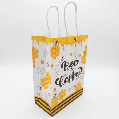 Saco de papel decorado com temática de abelhas e favo de mel com texto Bee Happy.