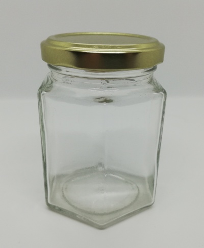 Frasco hexagonal de vidro transparente com tampa dourada