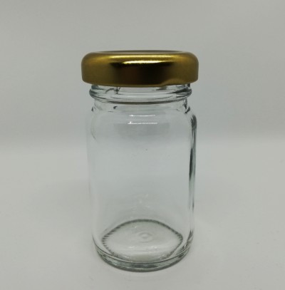 Frasco de vidro transparente com tampa dourada em fundo branco