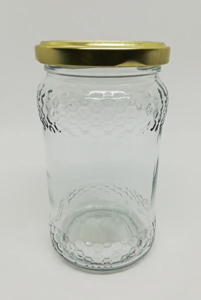 Frasco de vidro com padrão de favos de mel e tampa dourada