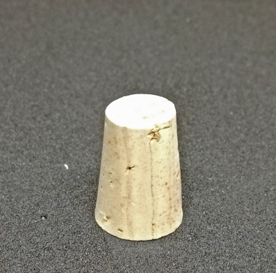 Rolha cónica de cortiça sobre superfície escura