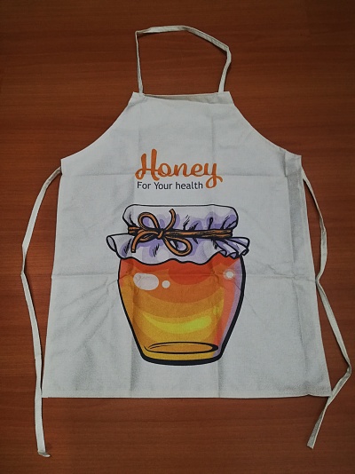 Avental branco com ilustração de frasco de mel e texto em laranja e preto