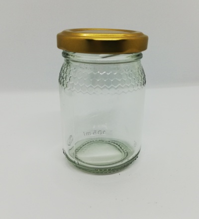 Frasco de vidro transparente com tampa dourada